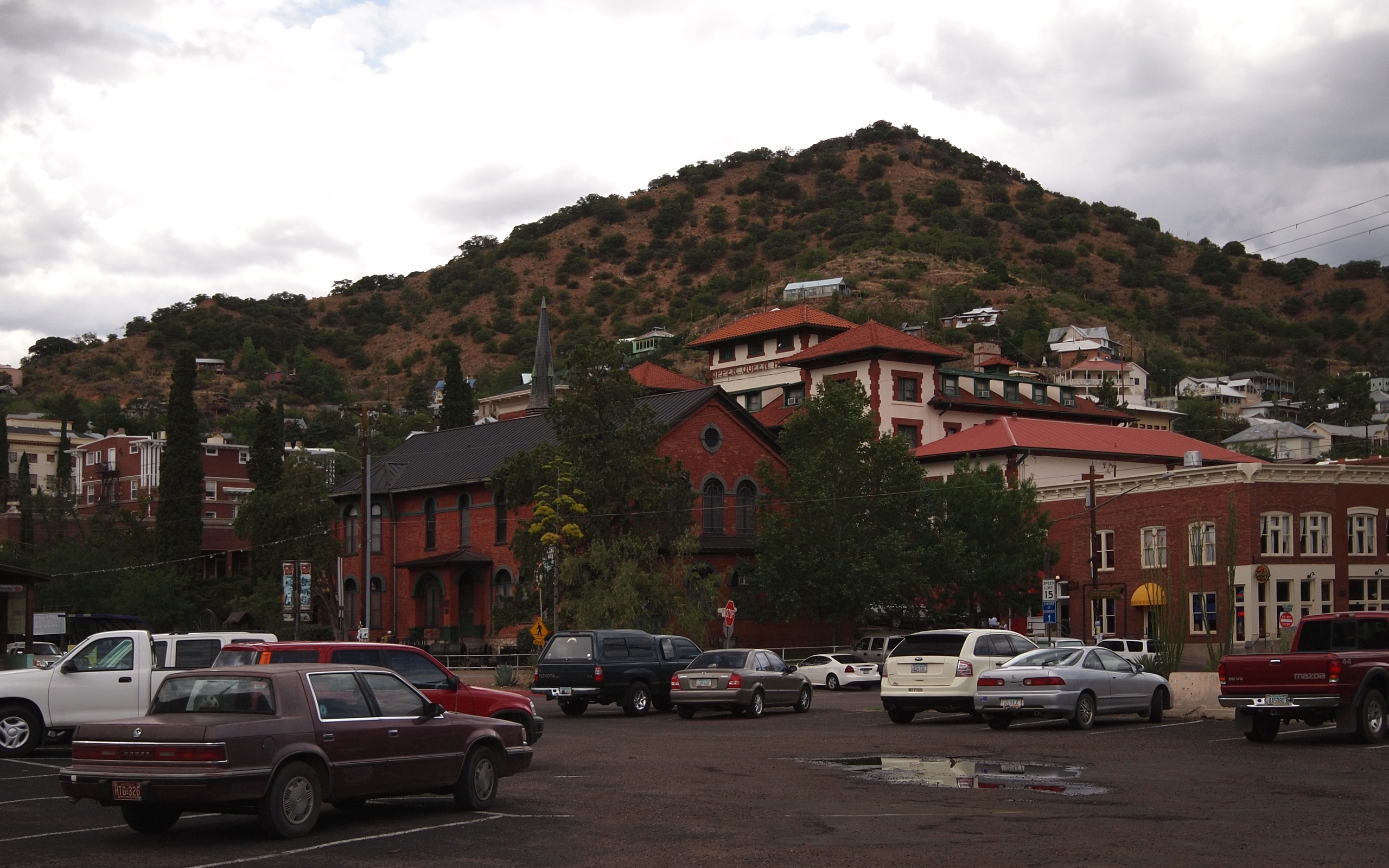 Downtown Bisbee, Arizona with brick buildings against the copper-colored mining hill behind