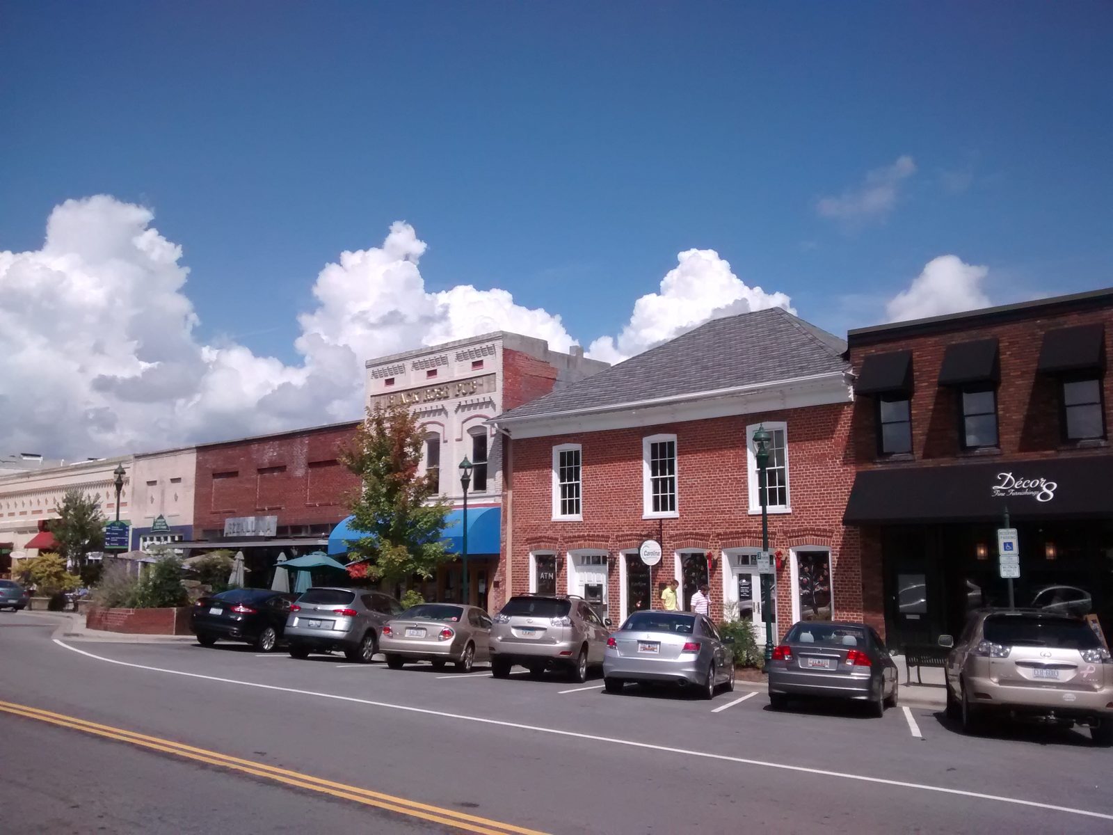 Brick storefronts and parked cars along Main Street in downtown Hendersonville, North Carolina