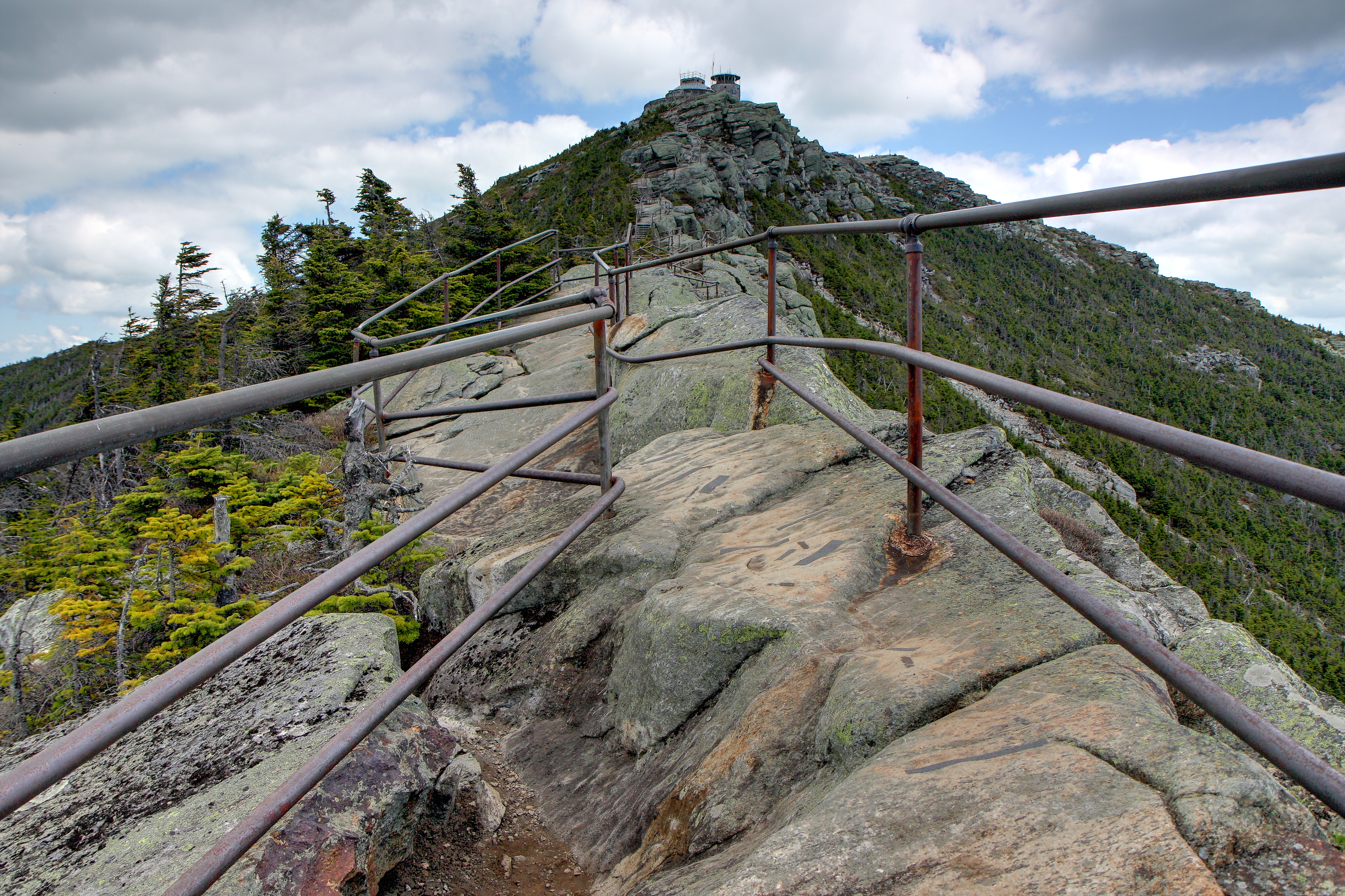 The rocky summit ridge of Whiteface Mountain near Lake Placid, with railings along the trail and the summit station ahead